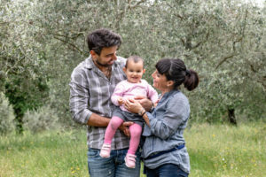 Couple with baby girl in garden, Florence, Italy Couple with baby girl in garden, Florence, Italy